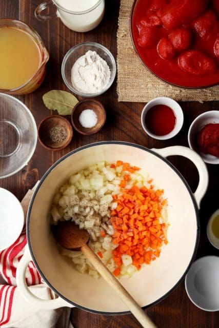 Browning carrots, onions, garlic and celery for creamy tomato soup recipe.