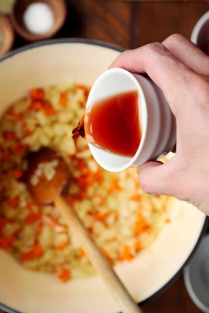 Adding a splash of red wine vinegar to tomato soup.
