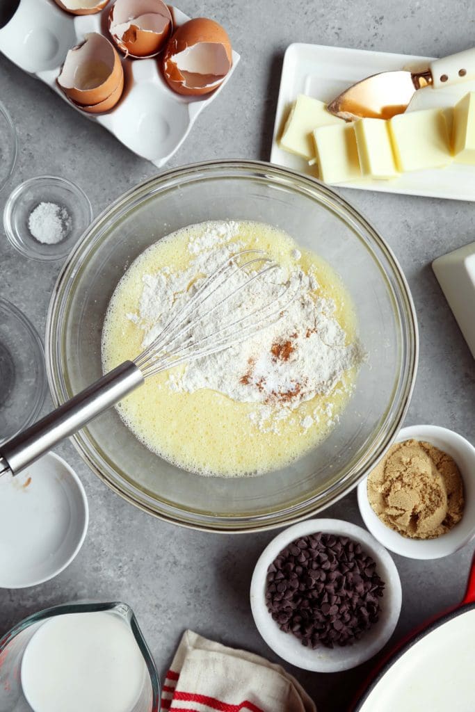 Beaten eggs in a claer bowl with flour and. cinnamon