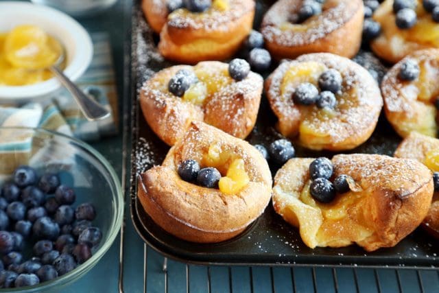 Christmas morning popovers sprinkled with blueberries in the pan
