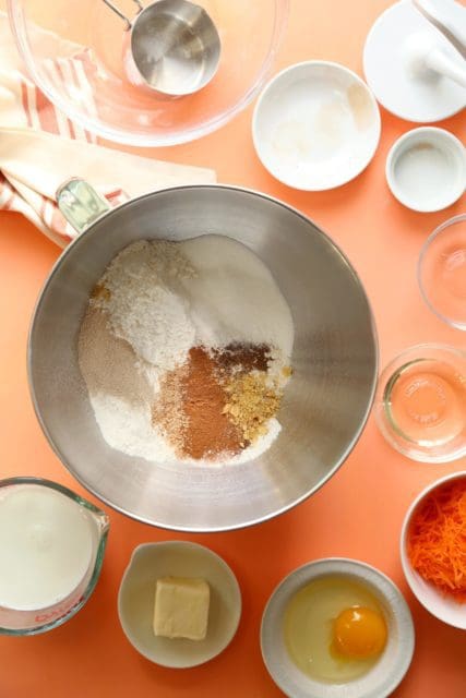 Dry ingredients for gluten free carrot cake cinnamon rolls in a mixing bowl.