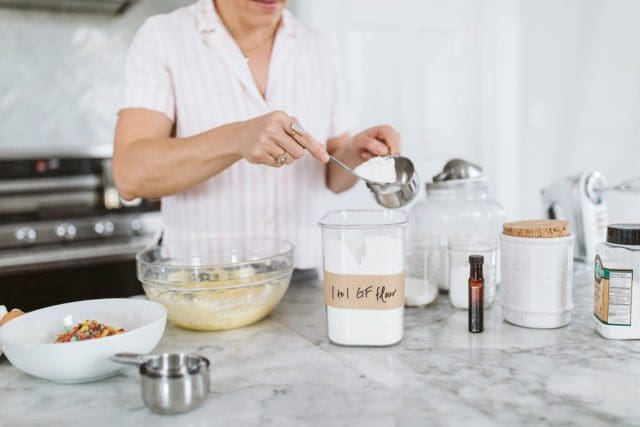 Measuring gluten free flour into a measuring cup.