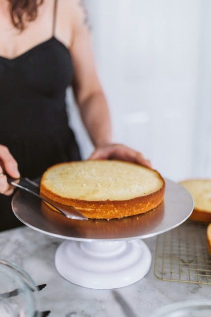 Slicing a vanilla cake layer in half