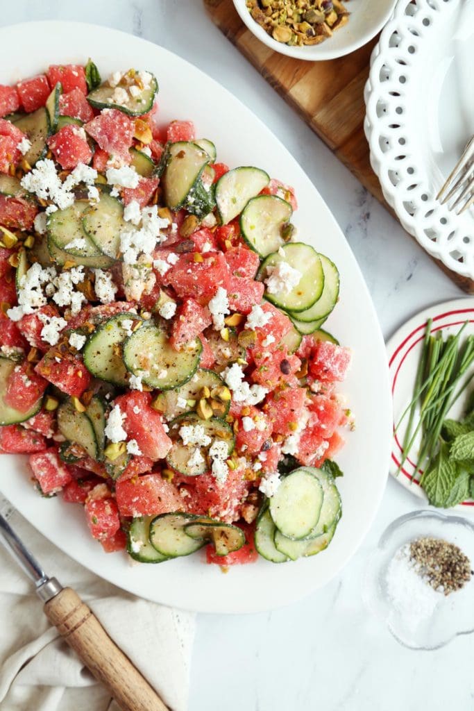 Easy watermelon salad tossed on an oval platter.