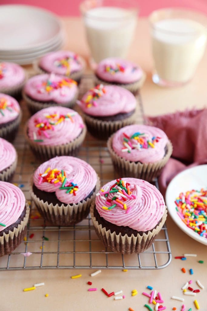 Chocolate Beet Cupcakes frosted on a wire rack with sprinkles.