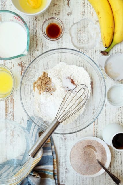 Dry ingredients for banana pancakes in a clear bowl.