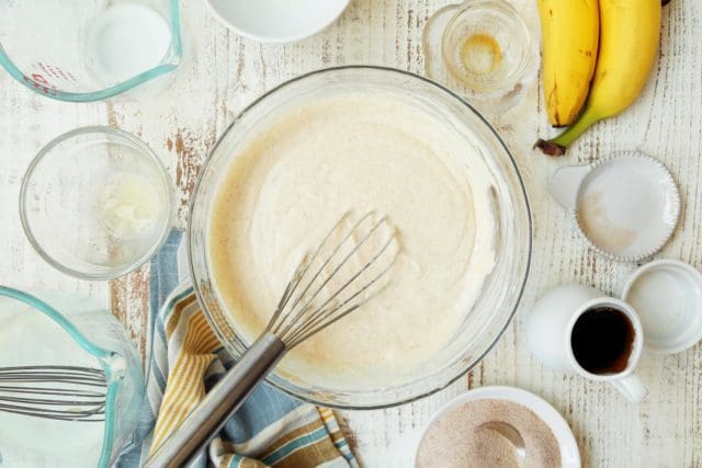 Whisked pancake batter in clear bowl.