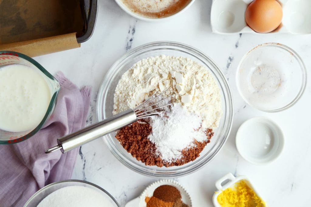 Flour, cocoa powder, baking soda, and salt in a bowl with a whisk.