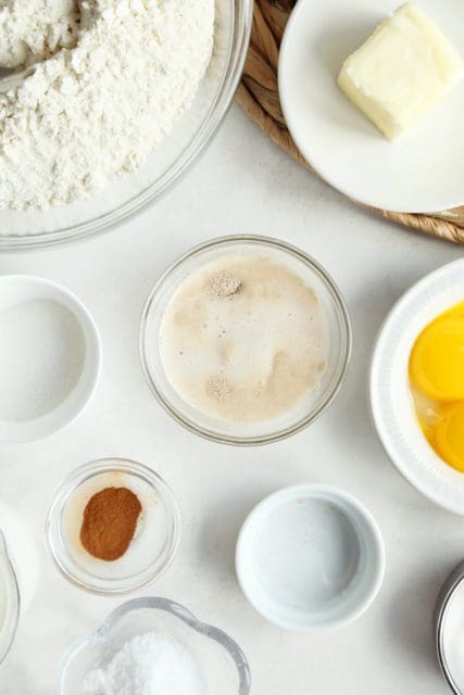 Yeast proofing in warm milk in small bowl for doughnut recipe.