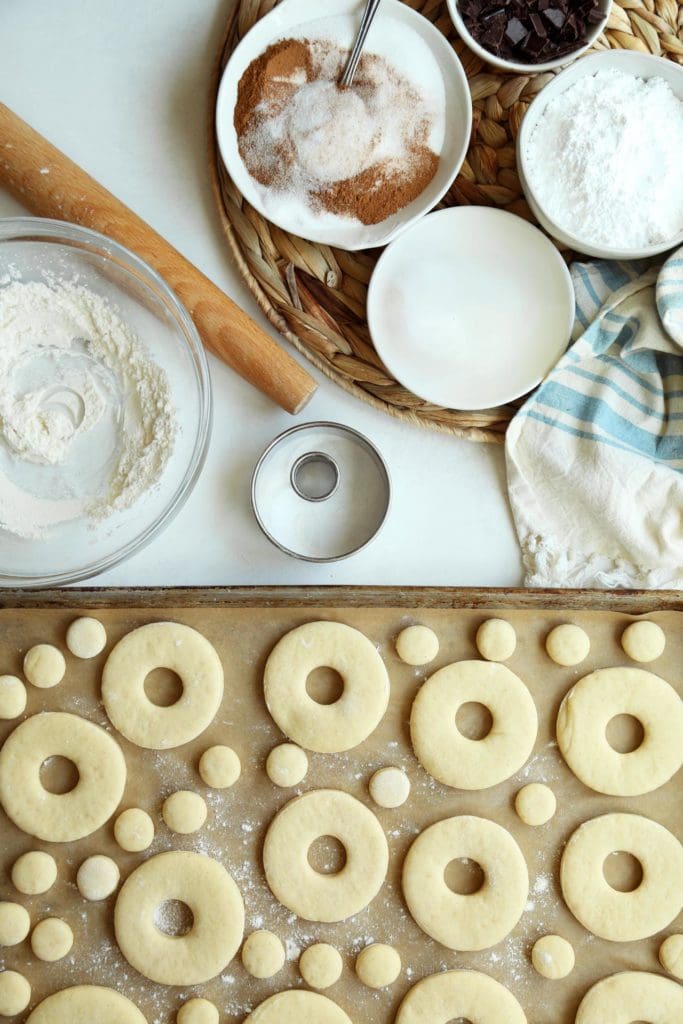 Classic doughnut recipe cut into doughnut shapes and holes.