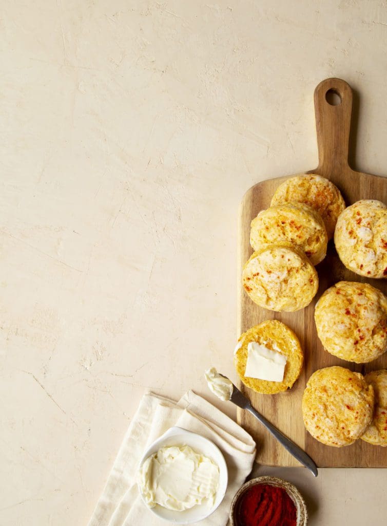 Baked sweet potato biscuits on a wooden cutting board.
