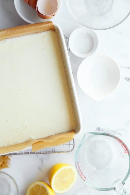 Lemon bar filling poured over crust to be baked.