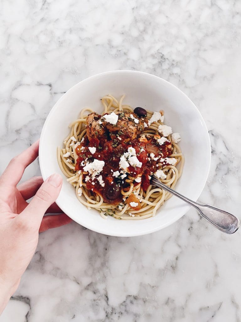 Bowl of baked chicken and pasta with a fork.