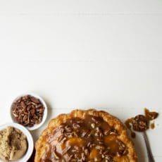 Apple praline pie in a dish with extra praline.