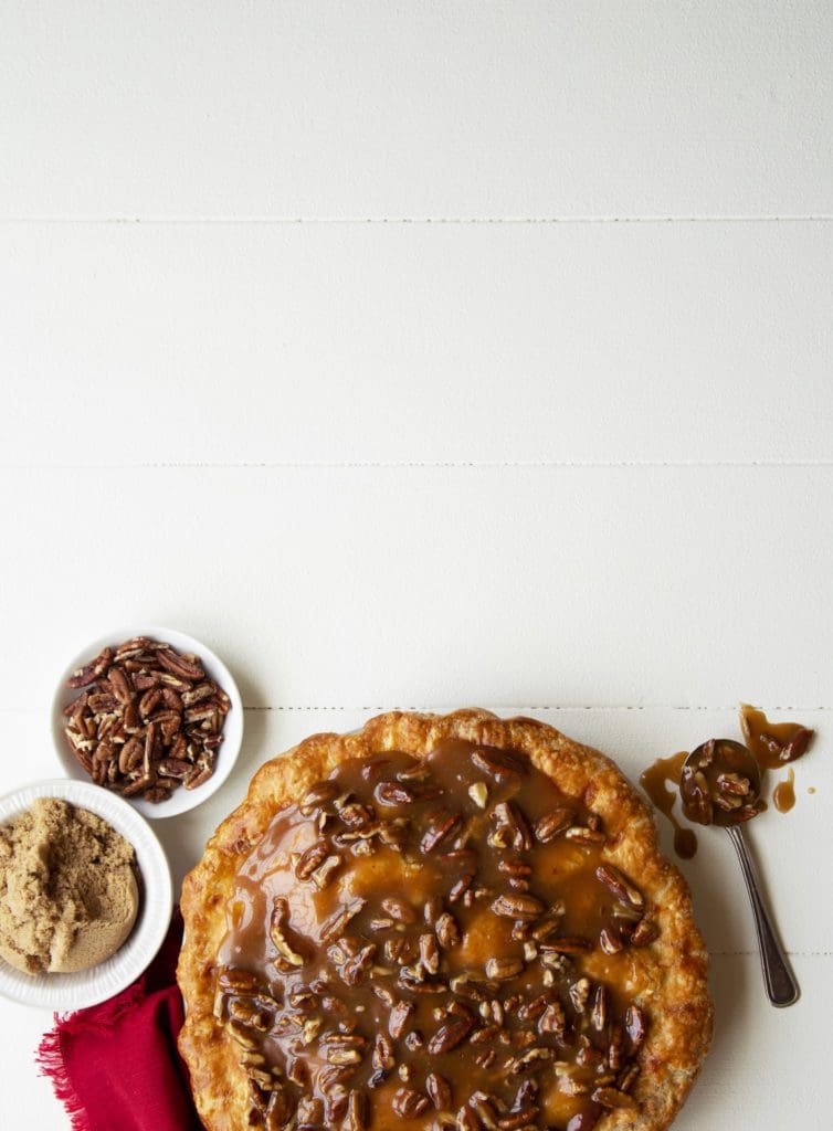Apple praline pie in a dish with extra praline.