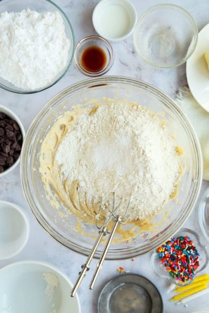 Dry ingredients for cookie cake recipe added to butter mixture.
