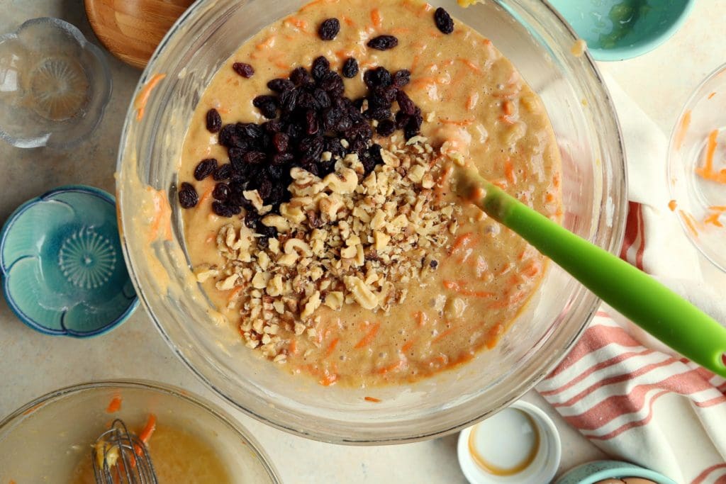 Walnuts and raisins added to carrot cake recipe.