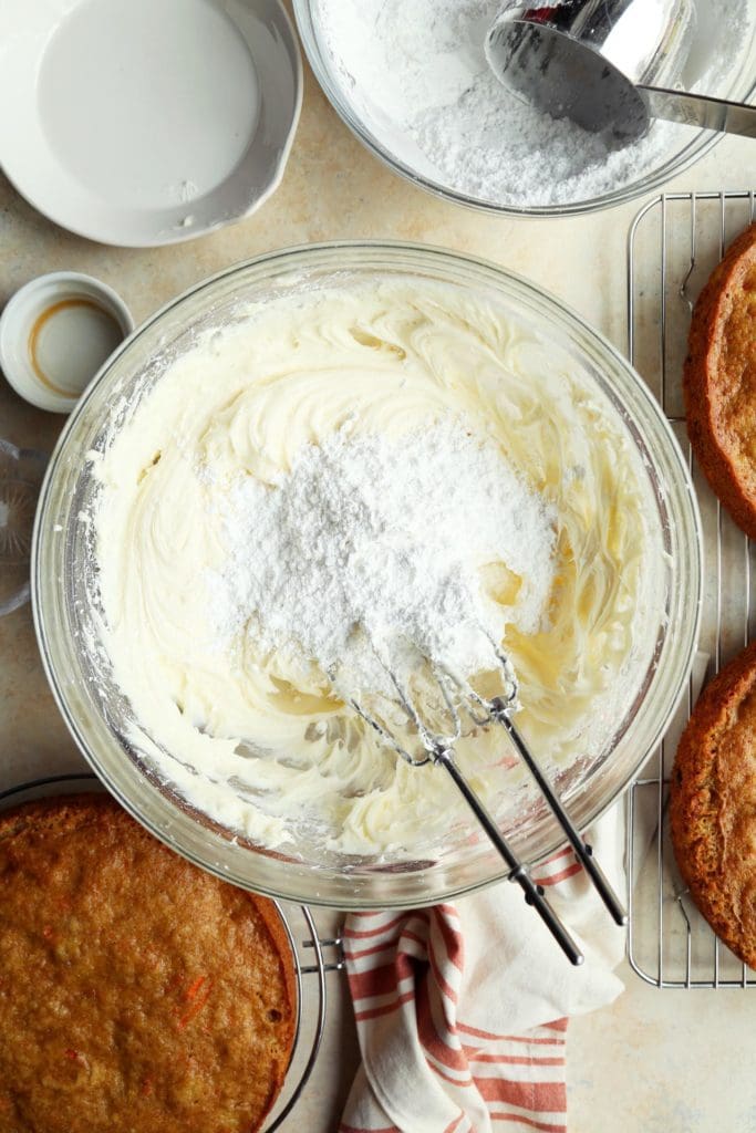 Powdered sugar added to the best cream cheese frosting for carrot cake recipe.