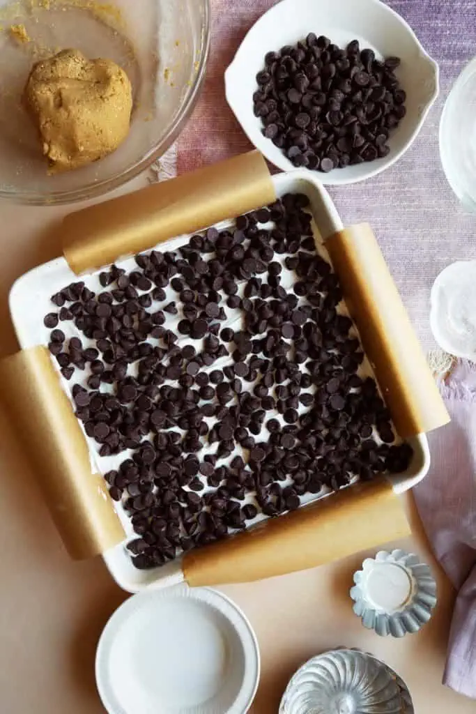Chocolate chops on top of marshmallow cream for moon pie recipe.