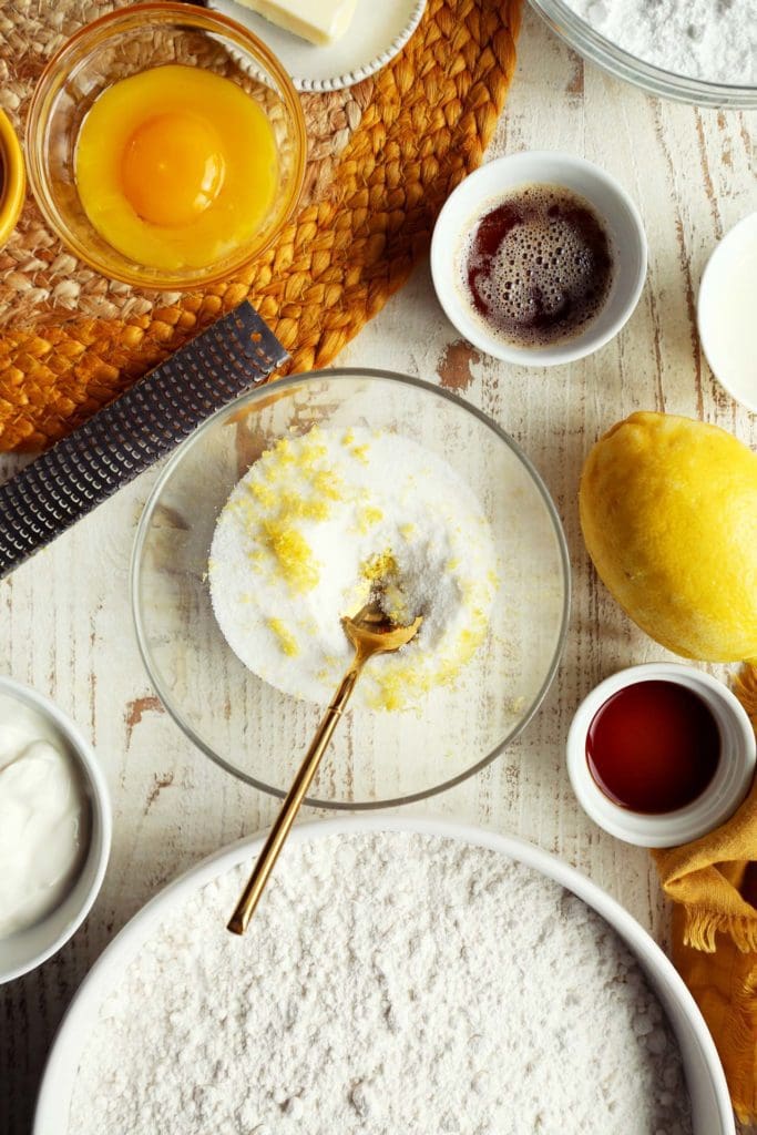 Mixing together sugar and lemon zest in a small bowl.