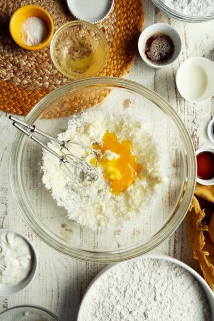 Mixing eggs into wet ingredients for lemon poppy seed doughnuts.