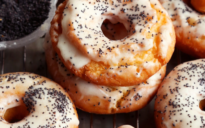 Two glazed doughnuts piled together.