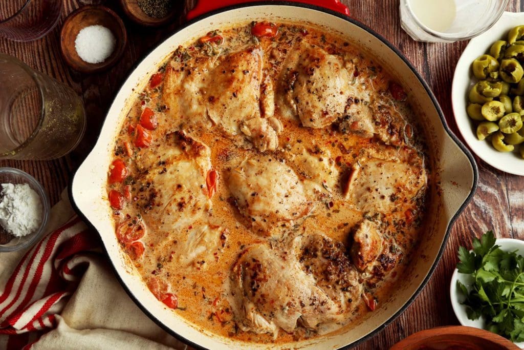 Chicken thighs added back to cream sauce for roasting.