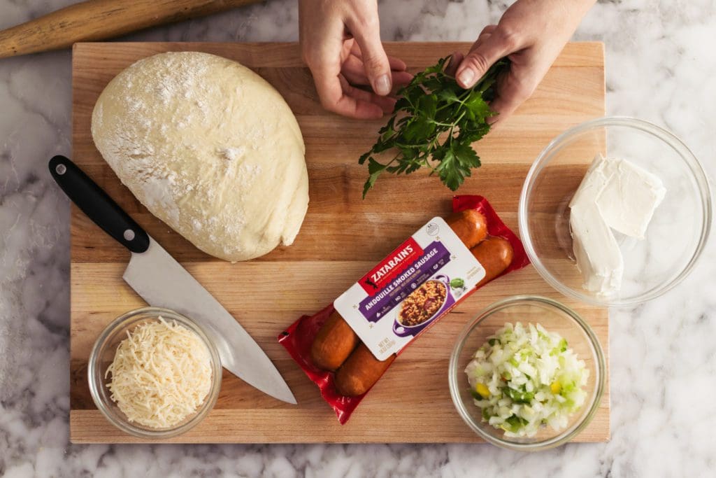 Ingredients for andouille sausage rolls on cutting board