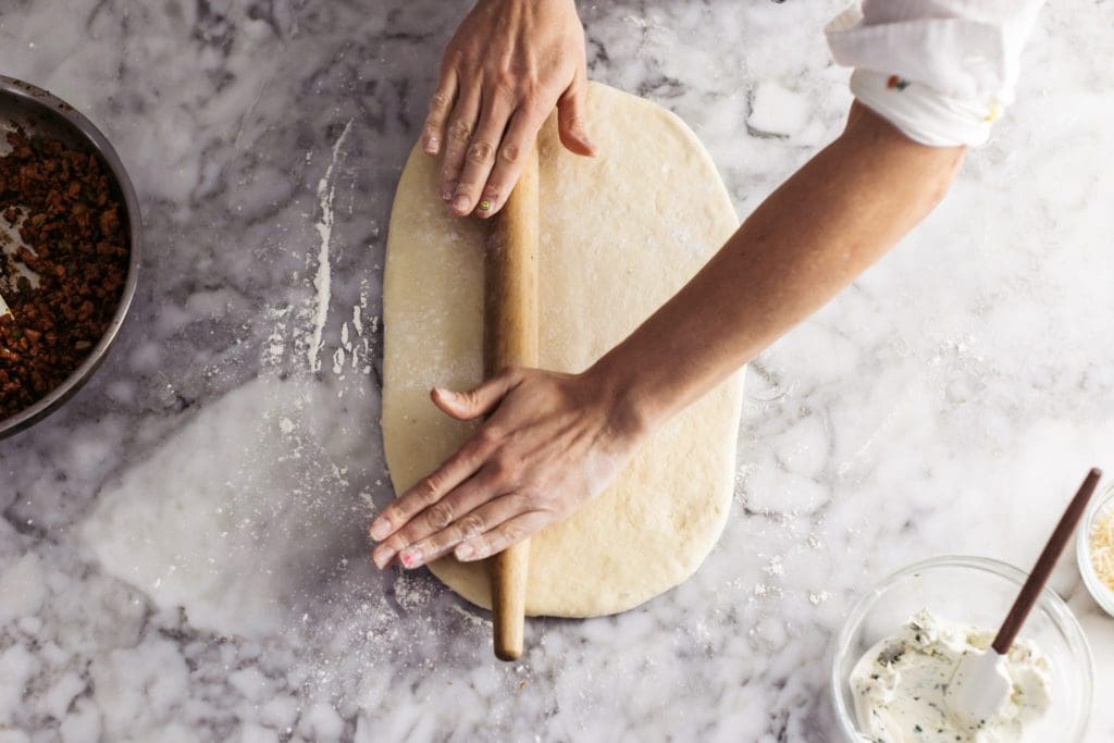 Rolling out yeasted dough.