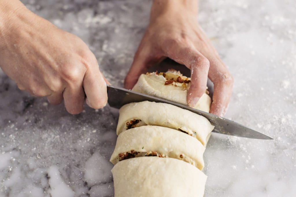 Slicing sausage rolls.