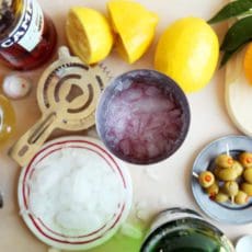 Gin sour ingredients with ice in a shaker.