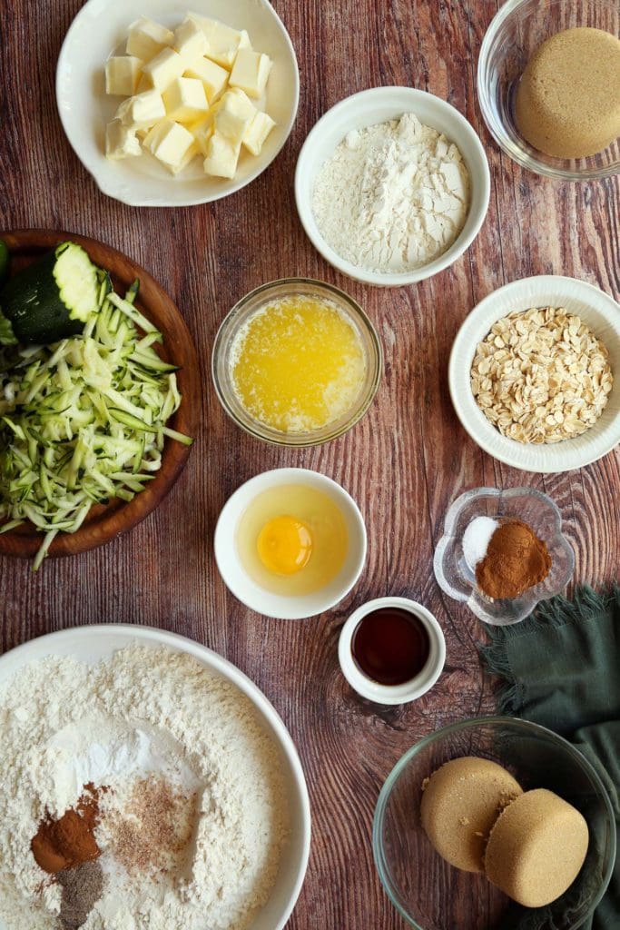 Ingredients for zucchini coffee cake recipe in small bowls.