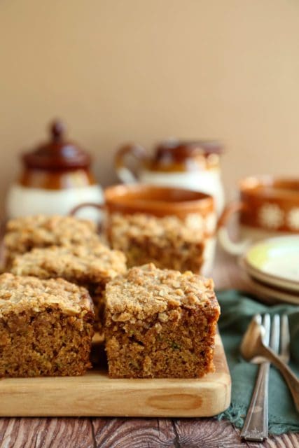 Coffee cake recipe cut into squares on a wooden board.