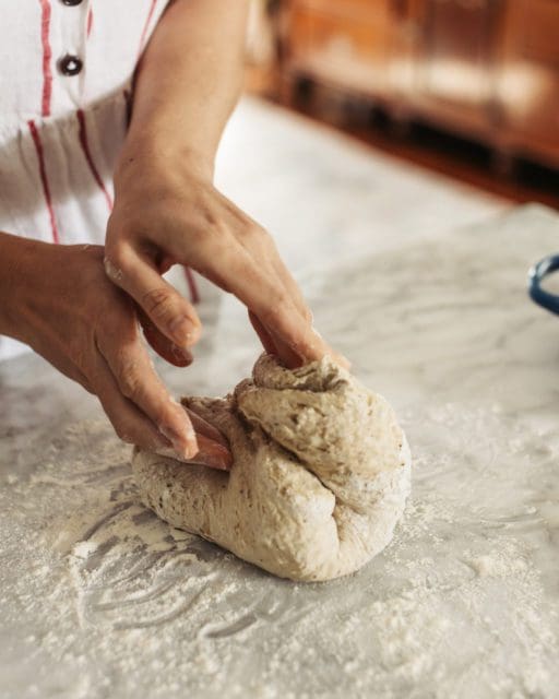 shaping no-knead rye bread into a ball.