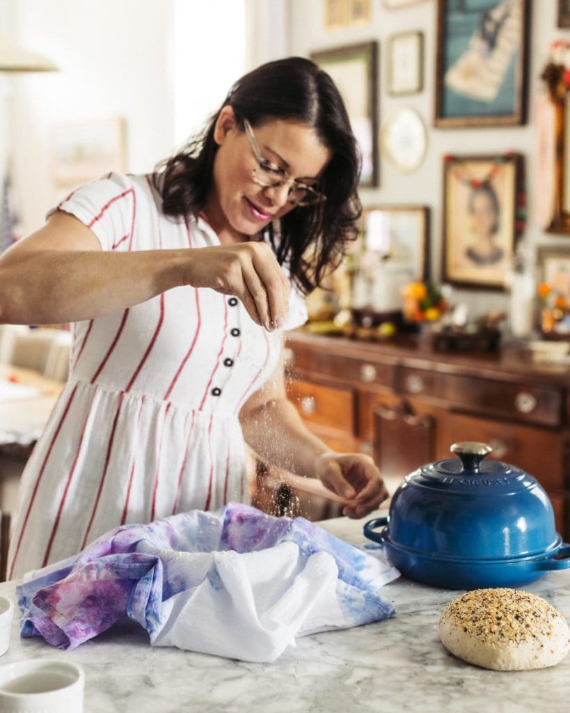 Sprinkling flour sack towel with flour for second rise.