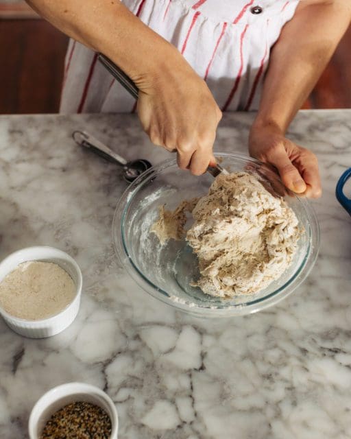 stirring together shaggy bread dough for overnight rise.