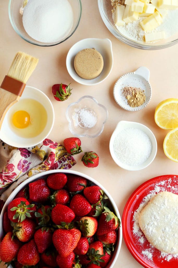 Ingredients for strawberry pie measured in small bowls.