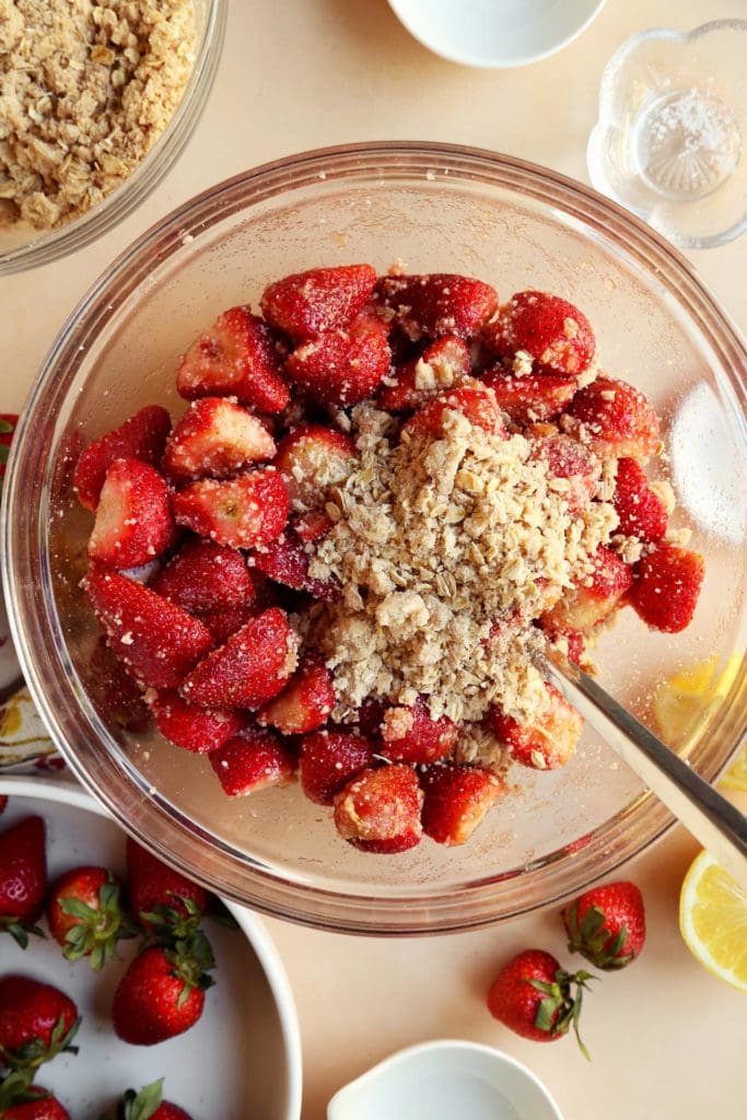 Sliced strawberry pie filling with a handful of crumble topping.