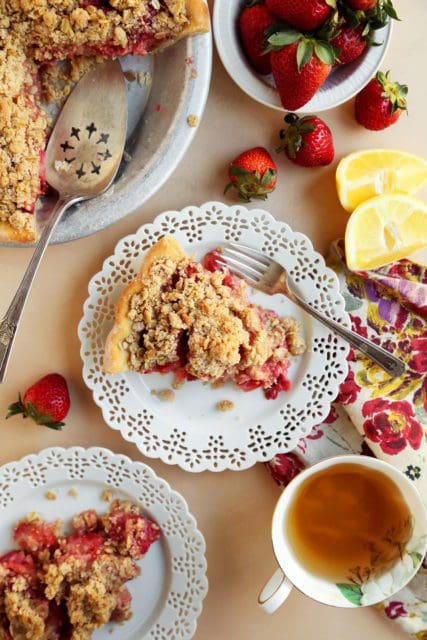 Slice of strawberry crumble pie with tea.