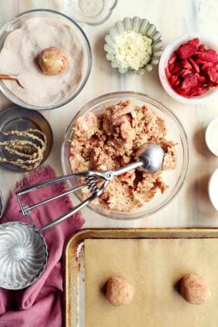 Chilled Taylor Swift sugar cookie dough with cookie scoop in bowl.