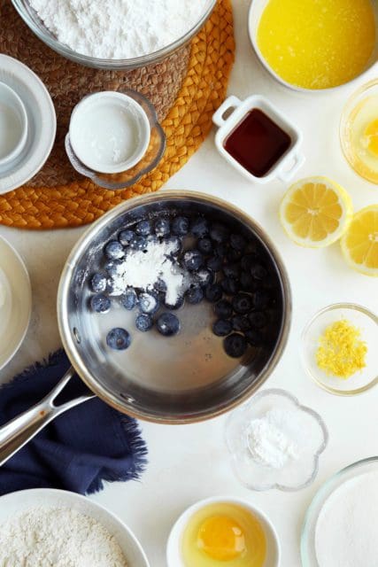 Fresh blueberries in pan with sugar and cornstarch for gooey butter cake.
