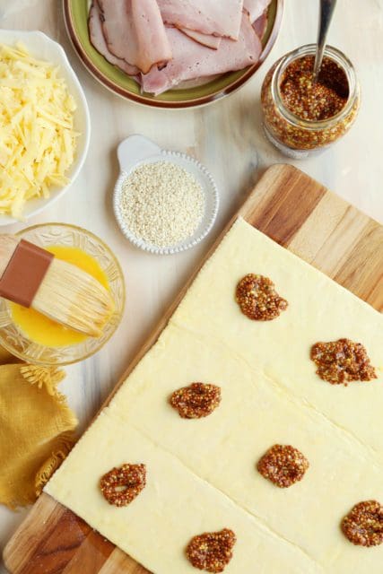 Mustard spread over unbaked puff pastry