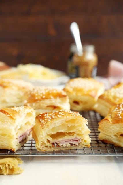 Cut up ham and cheese filled croissants on a wire rack