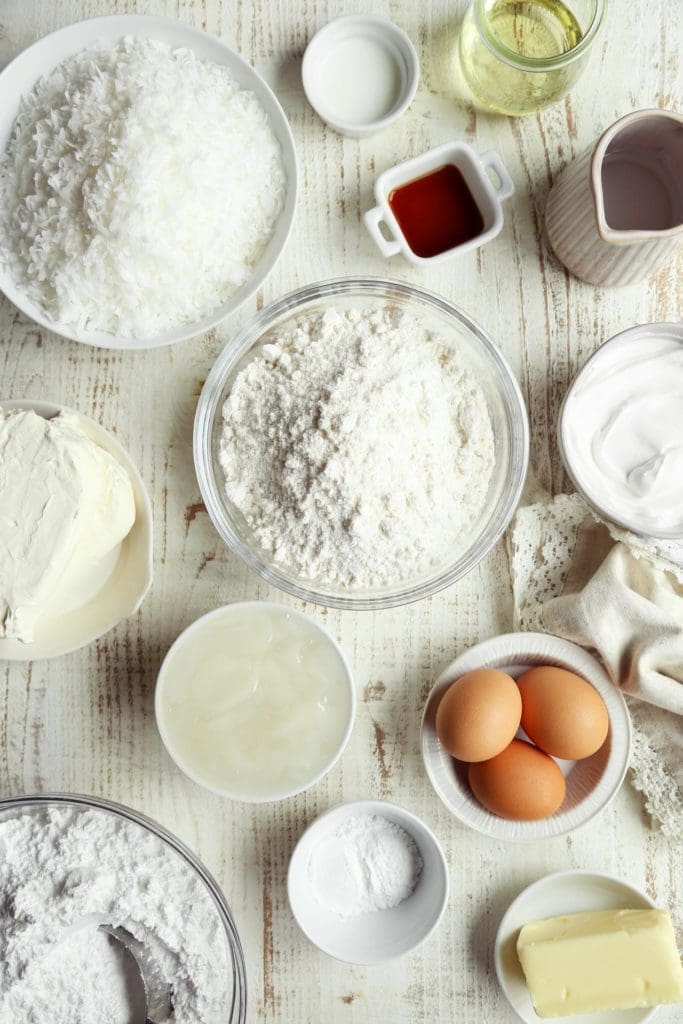 Ingredients for easy coconut cake measured in small bowls.