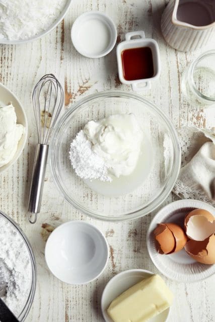 Sour cream topping for cake in small bowl.