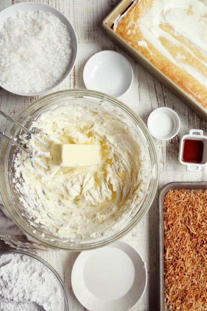Making cream cheese frosting in large bowl.