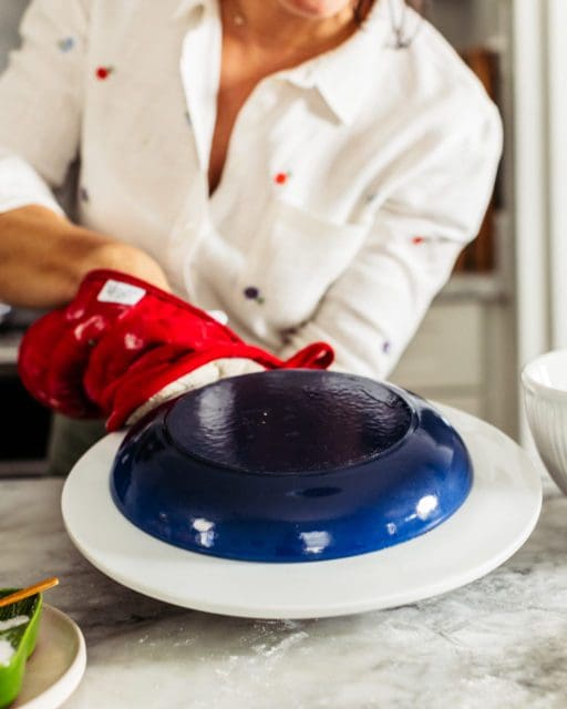 Inverting tomato pie recipe onto platter.