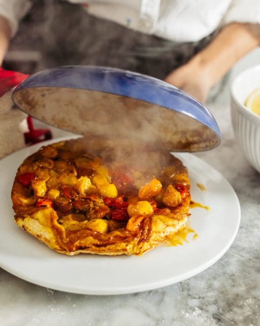 Lifting cast iron off of tomato pie.