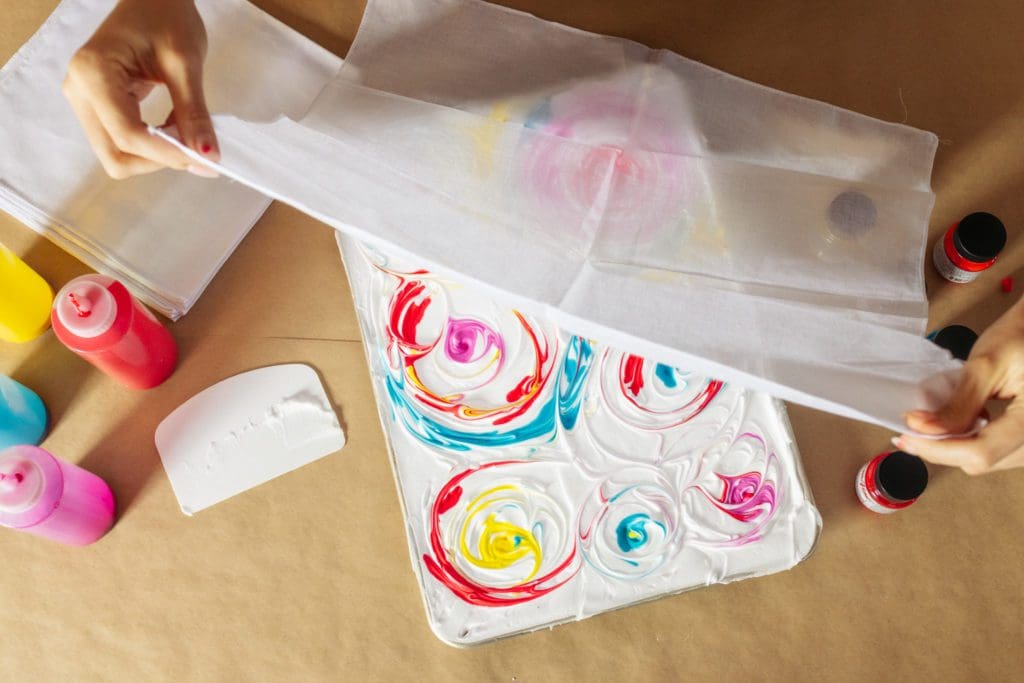 draping white bandana over dyed shaving cream