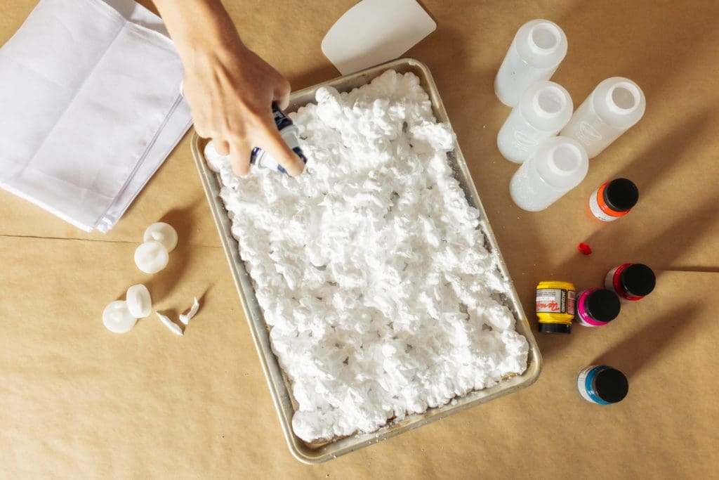 spraying shaving cream into a sheet pan.